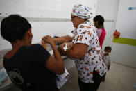 A nurse bathes a Yanomami baby at the Santo Antonio Children's Hospital, in Boa Vista, Roraima state, Brazil, Thursday, Jan 26, 2023. Brazil's government declared a public health emergency for the Yanomami people in the Amazon, who are suffering from malnutrition and diseases such as malaria. (AP Photo/Edmar Barros)