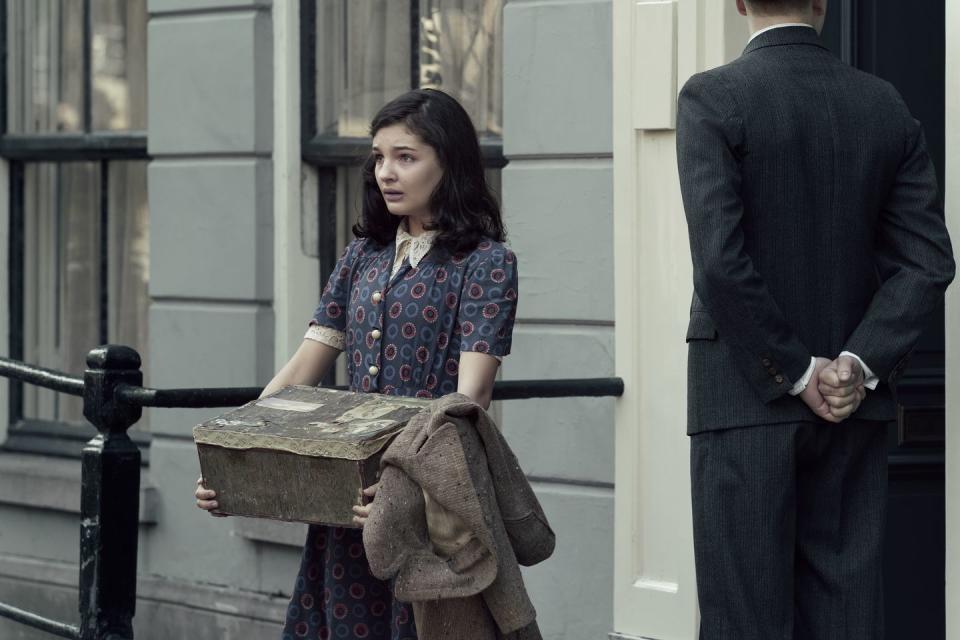 anne frank, played by billie boullet, walks out of the annex as seen in a small light credit national geographic for disneydusan martincek