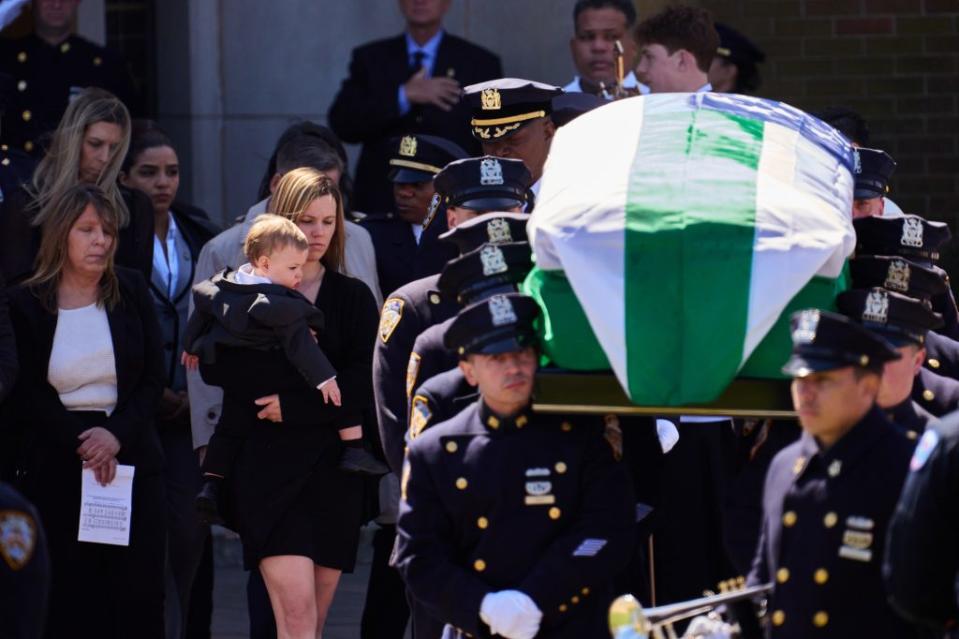 Stephanie Diller with her son, 1-year-old Ryan, at the funeral for her husband, NYPD cop Jonathan Diller. James Keivom