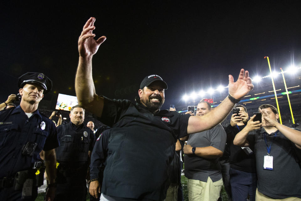 Ohio State coach Ryan Day celebrates as he walks off the filed after the team's win over Notre Dame in an NCAA college football game on Saturday, Sept. 23, 2023, in South Bend, Ind. (AP Photo/Michael Caterina)