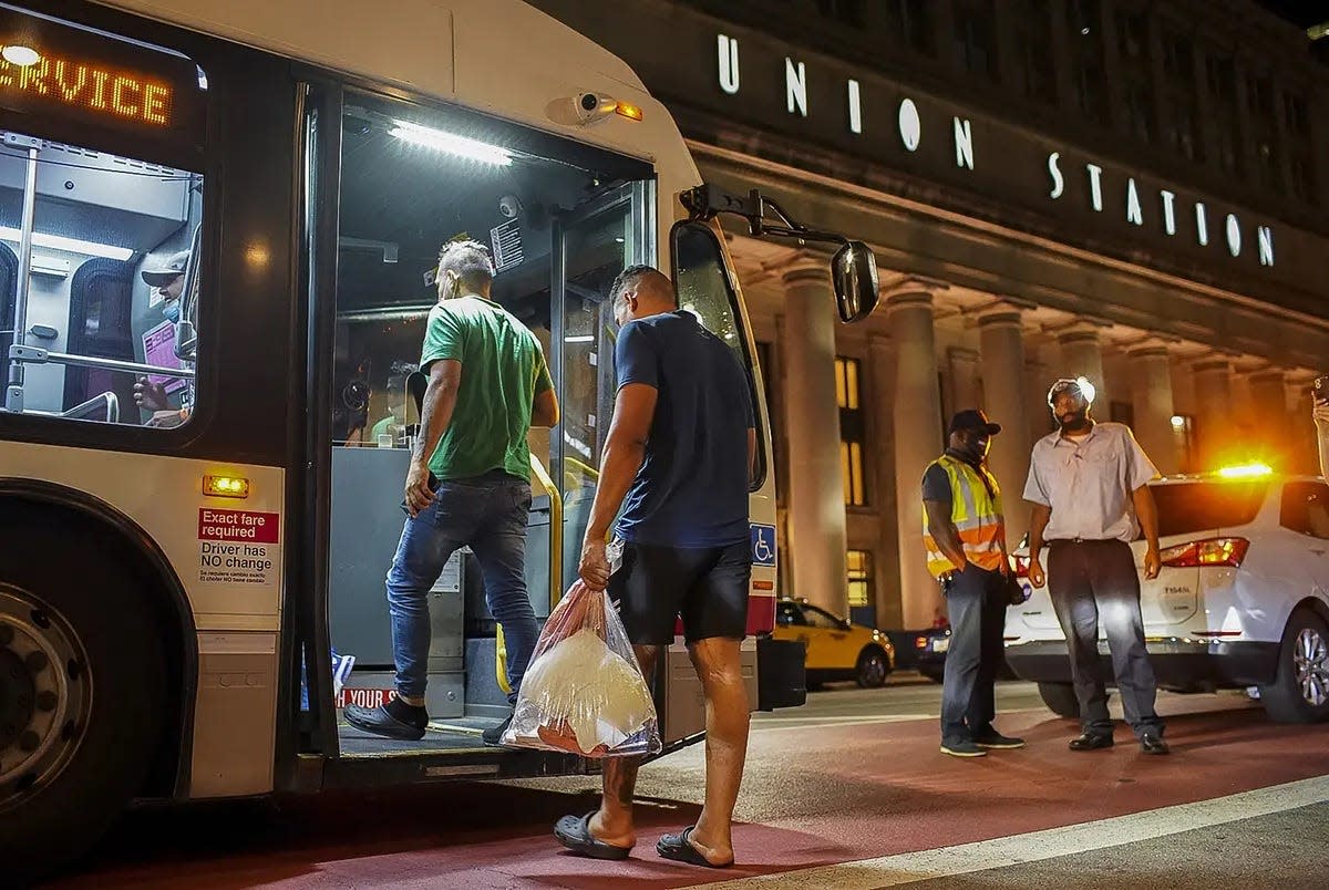A group of migrants boards a CTA bus at Chicago's Union Station to be taken to a Salvation Army shelter after arriving from Texas on Aug. 31, 2022.
