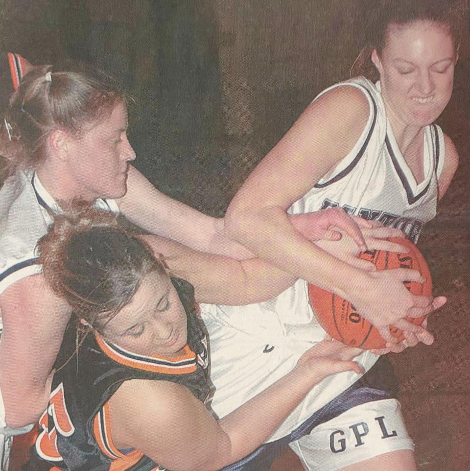 Great Plains Lutheran's Kelly Stone (right) and teammate Christina Mattick battle Doland-Conde's Adrienne Hiles for possession during a high school girls basketball game in January of 2003 in Watertown.