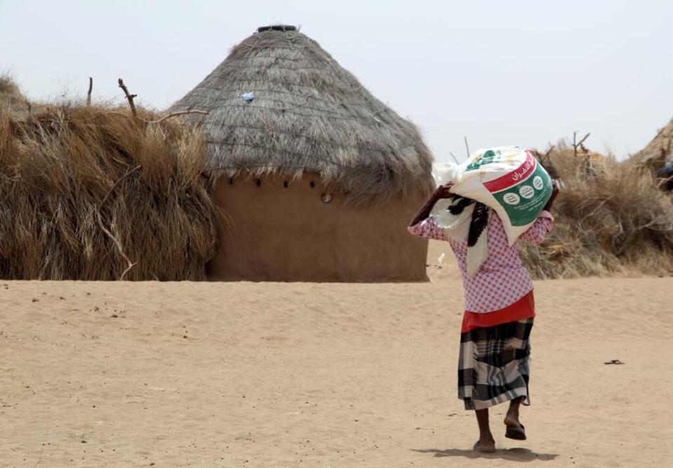 A displaced Yemeni, receives food aid and supplies at a camp in Hays district in Yemen’s war-ravaged western province of Hodeida on March 29, 2022, as food prices have doubled since last year and the fact that Ukraine supplies nearly a third of Yemen’s wheat imports has heightened fears of a deepening famine.(Photo by Khaled Ziad / AFP) (Photo by KHALED ZIAD/AFP via Getty Images)