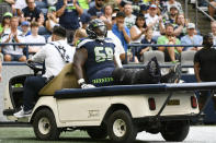 Seattle Seahawks guard Damien Lewis (68) is taken off the field on a cart after an injury during the first half of a preseason NFL football game against the Chicago Bears, Thursday, Aug. 18, 2022, in Seattle. (AP Photo/Caean Couto)