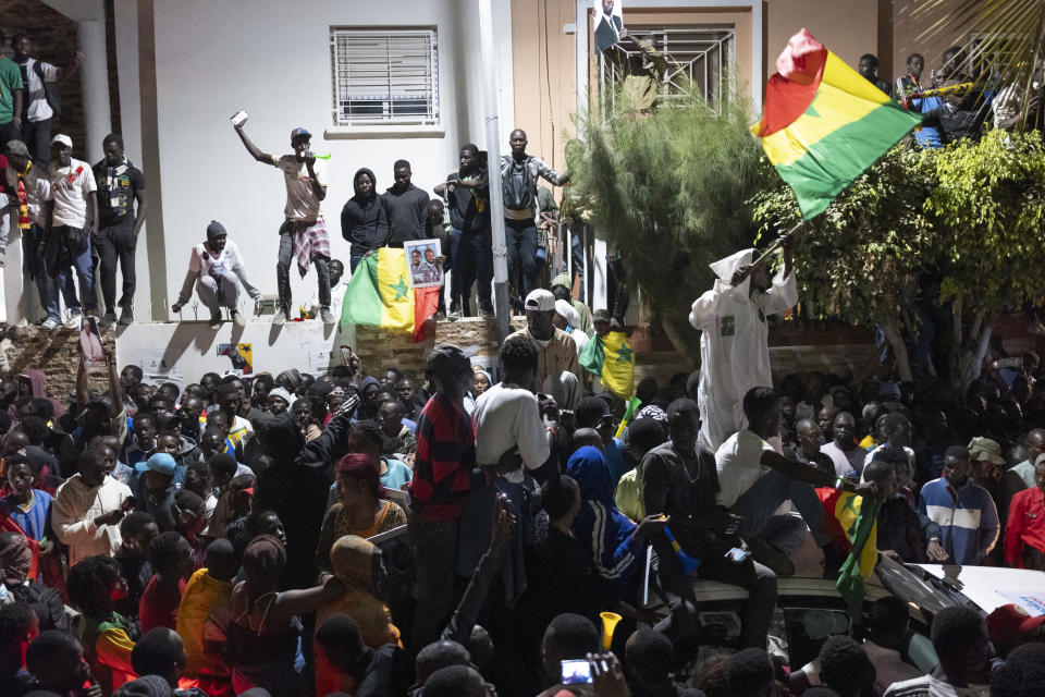 Supporters celebrate the release of Senegal's top opposition leader Ousmane Sonko and his key ally Bassirou Diomaye Faye outside Sonko's home in Dakar, Senegal, Thursday, March 14, 2024. Sonko had been in prison since July 2023 and has fought a prolonged legal battle to run for president in the March 24 election.(AP Photo/Sylvain Cherkaoui)
