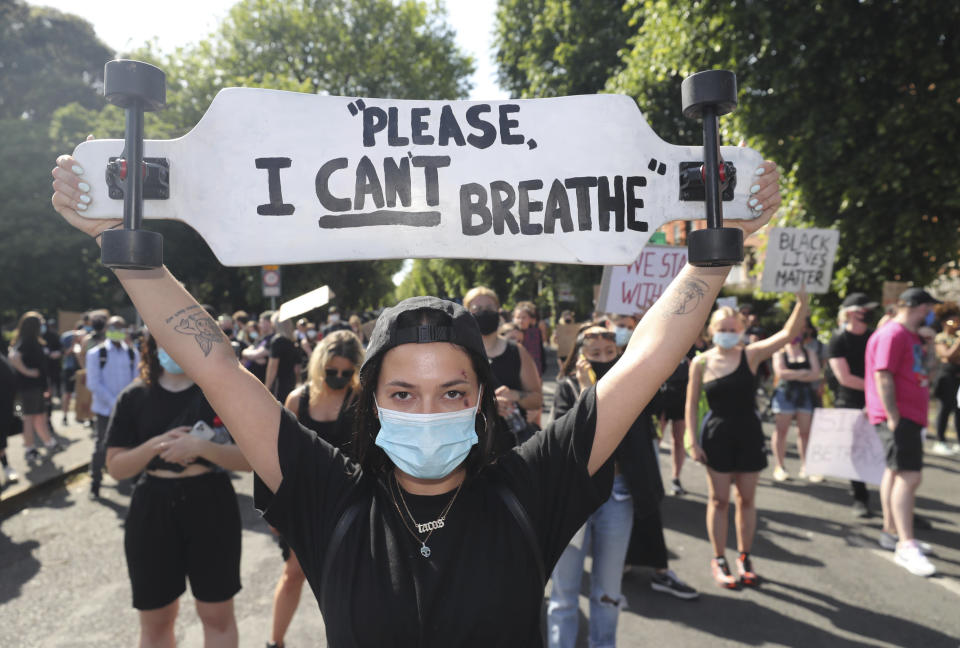 People protest under the slogan Black Lives Matter, and I Can't Breathe, rally outside the US Embassy in Dublin, Ireland, Monday June 1, 2020, following the death of George Floyd. The recent killing of George Floyd in Minneapolis, USA, has led to protests in many countries, and across the U.S. (Niall Carson/PA via AP)