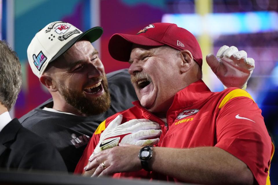 Kansas City Chiefs coach Andy Reid, right, and Travis Kelce celebrate their win after Super Bowl LVII.