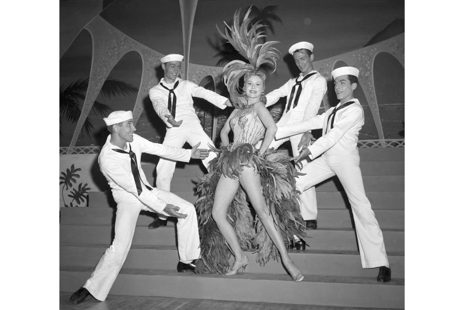 FILE - In this May 20, 1957 file photo, Actress Rhonda Fleming blossoms out as a singer and dancer in the first night club appearance of her career at the New Tropicana hotel in Las Vegas. When the Tropicana Las Vegas opened in 1957, Nevada's lieutenant governor at the time turned the key to open the door on what would become a Sin City landmark for more than six decades. Then he threw away the key. "This was to signify that the Tropicana would always stay open," said historian Michael Green. Six decades later, the storied hotel-casino that once had ties to the mob and had been nicknamed the "Tiffany of the Strip," is set to shut its doors for good to make room for a $1.5 billion Major League Baseball stadium. (AP Photo/David Smith, File)