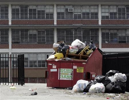 Trash overflows from a container in the parking lot of the Anna B. Pratt Elementary School, in North Philadelphia, shut down after the 2012-2013 school year, in this photo taken in Philadelphia, Pennsylvania September 5, 2013. REUTERS/Tom Mihalek