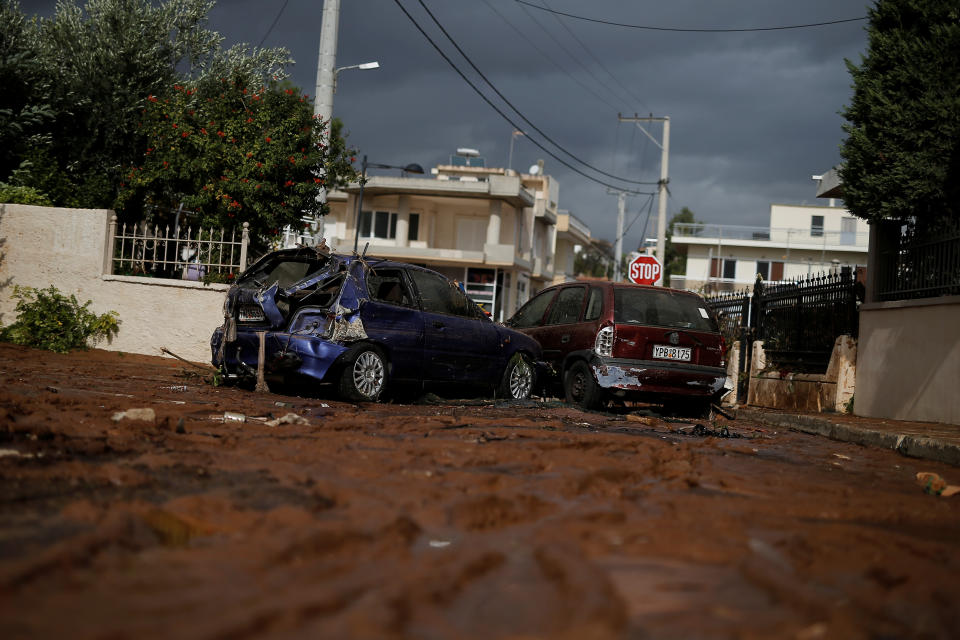 <p>Destroyed cars block a muddy road following a heavy rainfall in the town of Mandra, Greece, Nov. 15, 2017. (Photo: Alkis Konstantinidis/Reuters) </p>