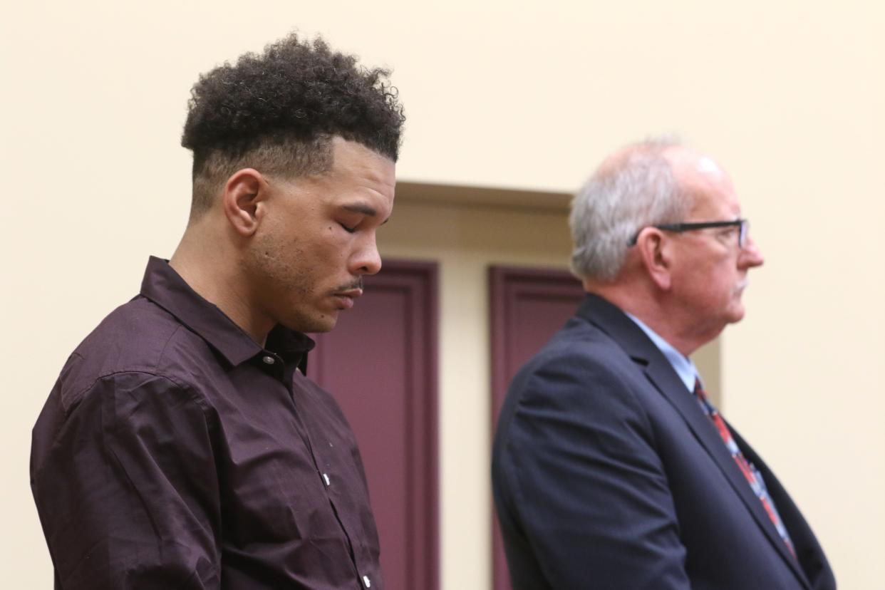 Michael Gillard, left, closes his eyes after being found guilty of rape in Muskingum County Common Pleas Court. On Tuesday he was sentenced to 10 years in prison.