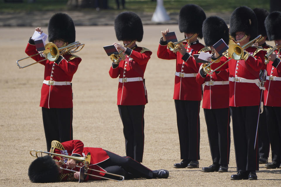 A trombone player in the military band faints during the Colonel's Review, the final rehearsal of the Trooping the Colour, the King's annual birthday parade, at Horse Guards Parade in London, Saturday, June 10, 2023. (Jonathan Brady/PA via AP)