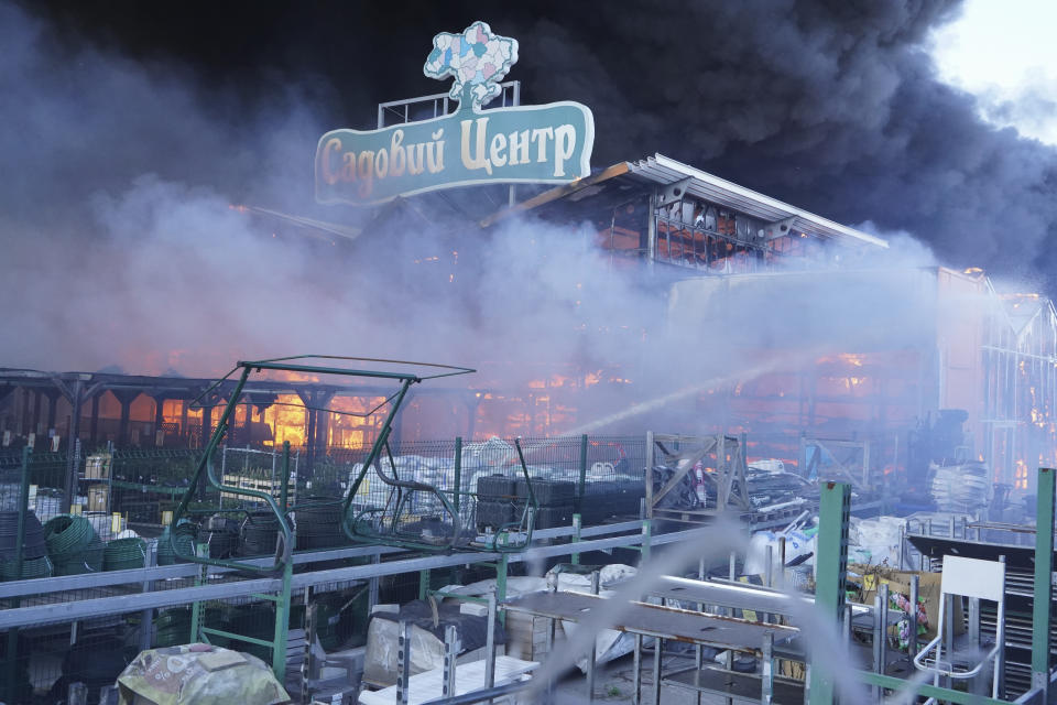 Firefighters put out a fire after two guided bombs hit a large construction supplies store in Kharkiv, Ukraine, Saturday, May 25, 2024. Writing reads "Garden Center". (AP Photo/Andrii Marienko)