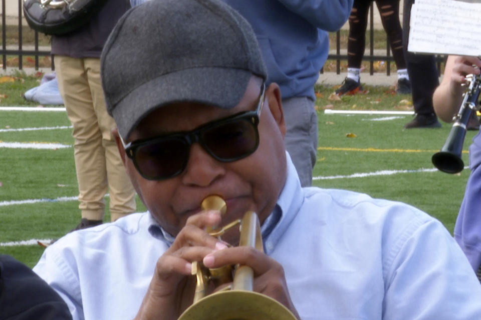 In this image made from video, Wynton Marsalis plays the trumpet during a rehearsal with the Michigan Marching Band on Thursday, Oct. 13, 2022, in Ann Arbor, Mich. The Grammy and Pulitzer winner is taking part in a week-long residency at the University of Michigan. (AP Photo/Mike Householder)