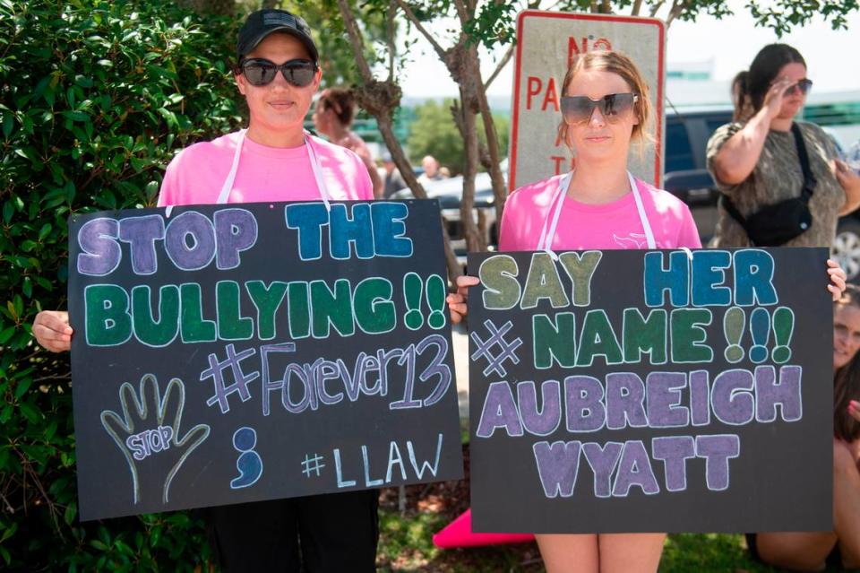 Chasedy Ferrer, of Hurley, and Wynonna Harris, of Vancleave, hold signs in support of Aubreigh Wyatt outside the Jackson County Courthouse in Pascagoula on Thursday, July 18, 2024.