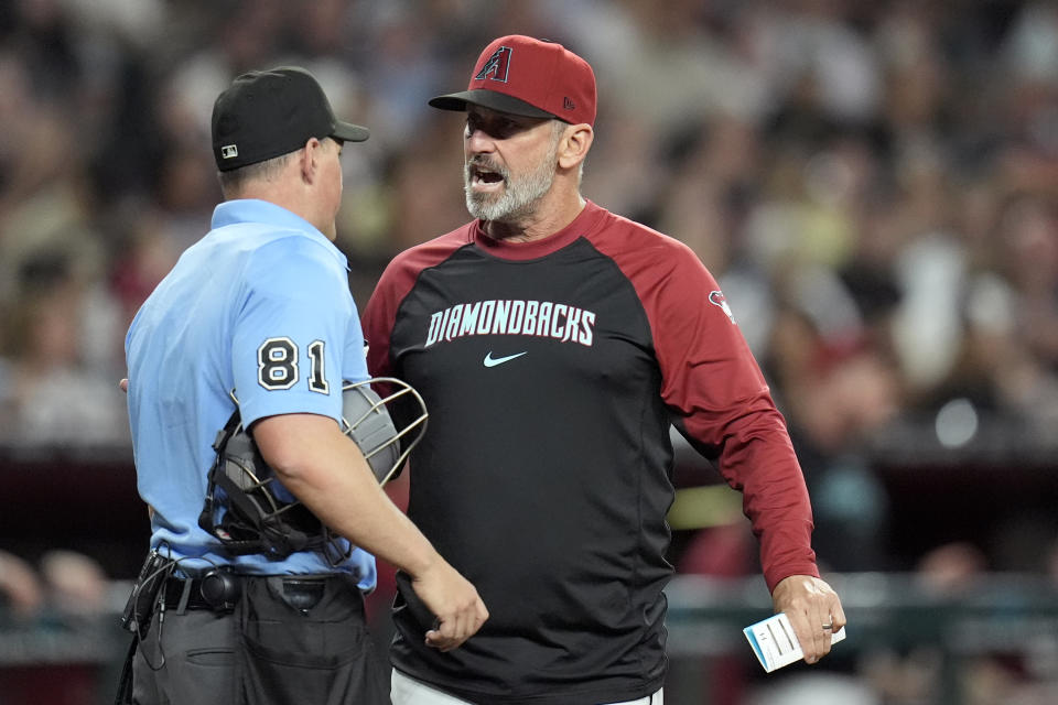 Arizona Diamondbacks manager Torey Lovullo, right, argues with umpire Quinn Wolcott during the fifth inning of the team's baseball game against the St. Louis Cardinals on Friday, April 12, 2024, in Phoenix. (AP Photo/Ross D. Franklin)