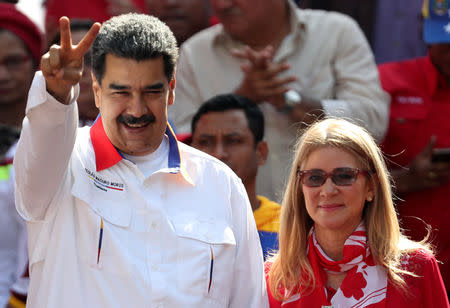 Venezuela's President Nicolas Maduro greets people next to his wife Cilia Flores during a rally in support of the government in Caracas, Venezuela May 20, 2019. REUTERS/Ivan Alvarado