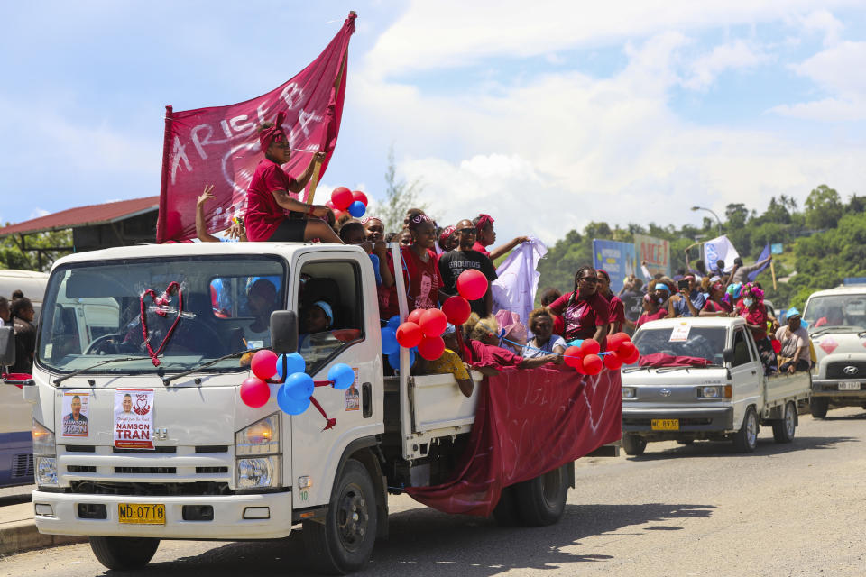 Locals react as they participate in a candidates parade in the capital Honiara, Solomon Islands, Monday, April 15, 2024. The country in which China has gained most influence in the South Pacific, Solomon Islands, goes to the polls on Wednesday in an election that could shape the region's future. (AP Photo/Charley Priringi)