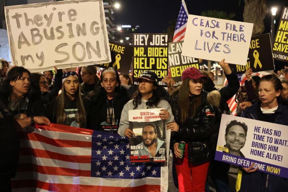 A photo of protesters holding placards outside of a US embassy in Tel Aviv