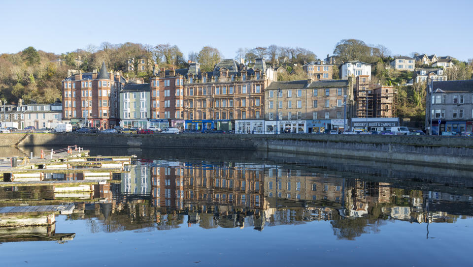 Buildings at Rothesay port reflected in clear water (Getty Images)