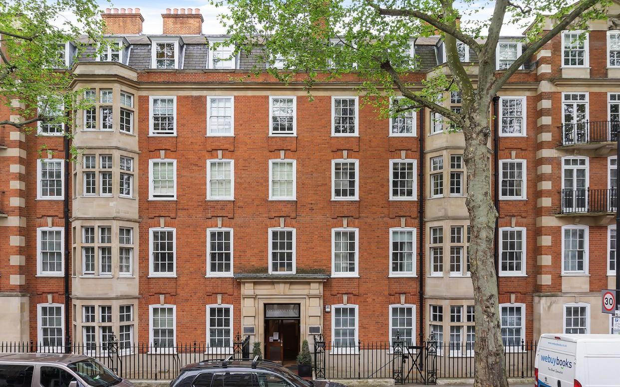 This red brick mansion block in South Kensington has sweeping communal gardens