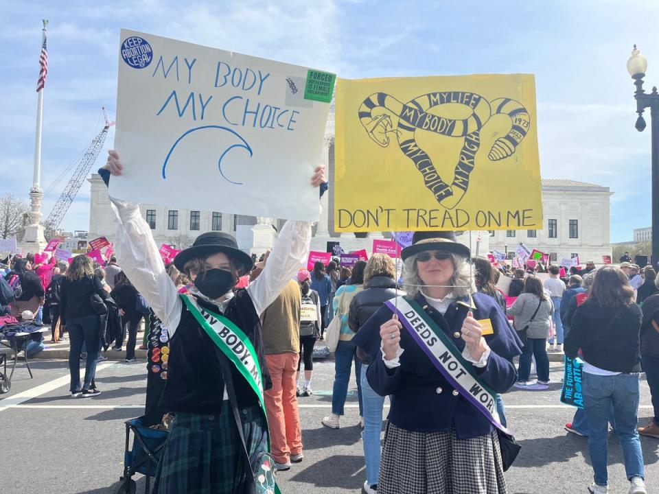 Darcy Nair, right, participates in an abortion rights demonstration dressed as a suffragette (Katie Hawkinson/The Independent)