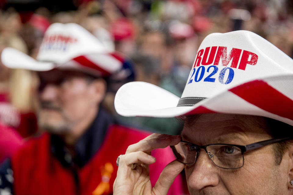 Members of the audience wear "Trump 2020" cowboy hats as President Donald Trump speaks at a campaign rally at American Airlines Arena in Dallas, Texas, Thursday, Oct. 17, 2019. (AP Photo/Andrew Harnik)