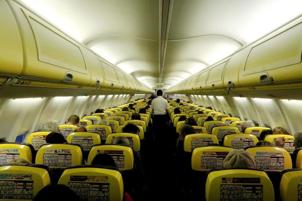 Strike: A cabin crew member serves passengers (REUTERS)
