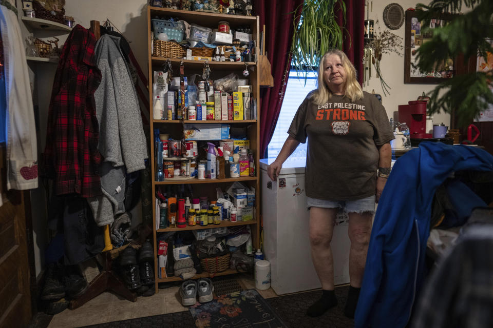 Sam Chirico wears an "East Palestine Strong" t-shirt as she stands in her kitchen in East Palestine, Ohio, on Tuesday, Jan. 30, 2024. Daily life largely returned to normal for residents of East Palestine, Ohio, months after a Norfolk Southern train derailed and spilled a cocktail of hazardous chemicals that caught fire a year ago, but the worries and fears are always there. (AP Photo/Carolyn Kaster)