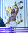 <p>Alicia Keys waves from atop the Radio City Music Hall marquee in N.Y.C. on Aug. 11 ahead of her concert there that evening. </p>