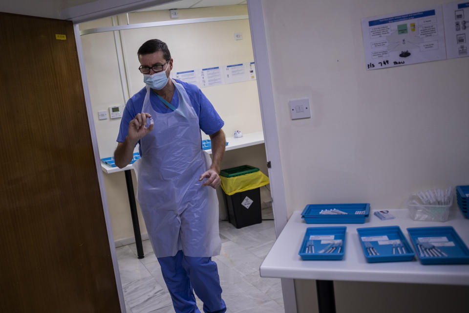 A health worker holds a Pfizer-BioNTech COVID-19 vaccine at the vaccination centre in Gibraltar, Thursday, March 4, 2021. Gibraltar, a densely populated narrow peninsula at the mouth of the Mediterranean Sea, is emerging from a two-month lockdown with the help of a successful vaccination rollout. The British overseas territory is currently on track to complete by the end of March the vaccination of both its residents over age 16 and its vast imported workforce. But the recent easing of restrictions, in what authorities have christened “Operation Freedom,” leaves Gibraltar with the challenge of reopening to a globalized world with unequal access to coronavirus jabs. (AP Photo/Bernat Armangue)