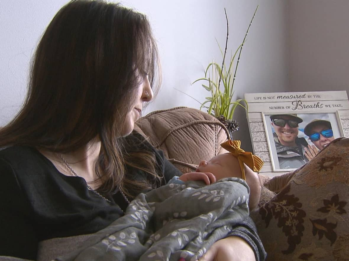 Stacy Benson sits with her newborn daughter, Halen Benson, in Pincher Creek, Alta. The area's surgeon is sounding the alarm over maternal care staffing in the area.   (Justin Pennell/CBC - image credit)