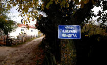 A sign reading "General Mladic Street" hangs on a tree in the village where the former Bosnian Serb military commander Ratko Mladic was born, Bozanovici, Bosnia and Herzegovina, November 8, 2017. REUTERS/Dado Ruvic