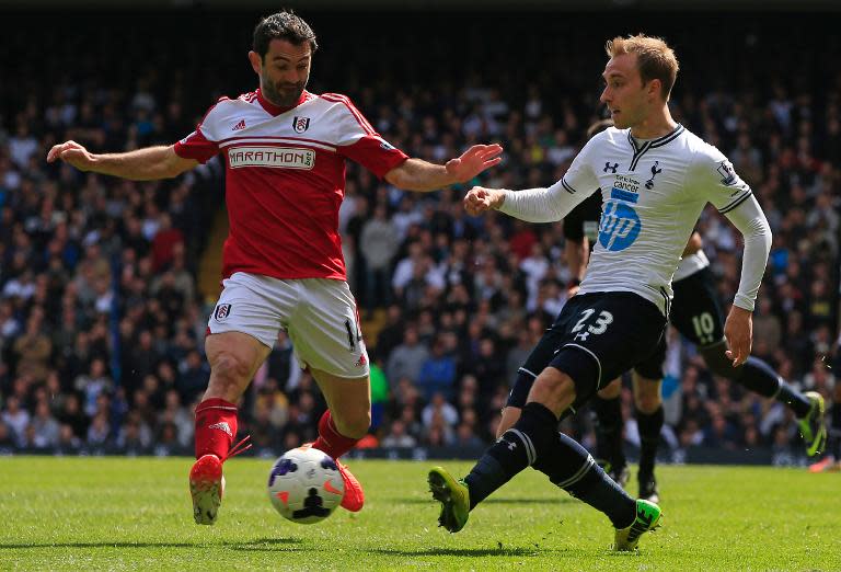 Tottenham Hotspur's Danish midfielder Christian Eriksen (R) and Fulham's Greek midfielder Giorgos Karagounis (L) during a football match between Tottenham Hotspur and Fulham in London, April 19, 2014, which Tottenham Hotspur won 3-1