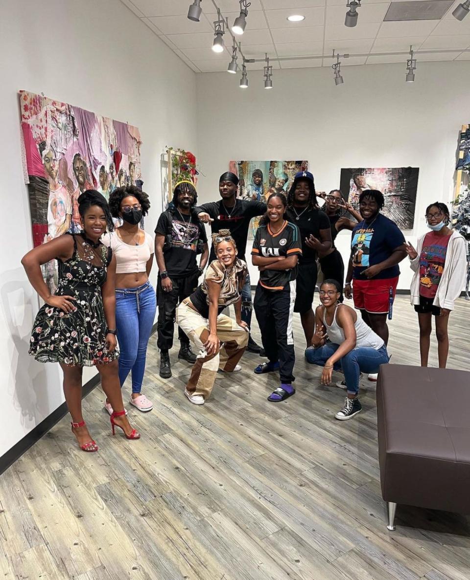 Members of SSU's Art Club attend the opening reception of Gabe Torres' recent on-campus exhibition