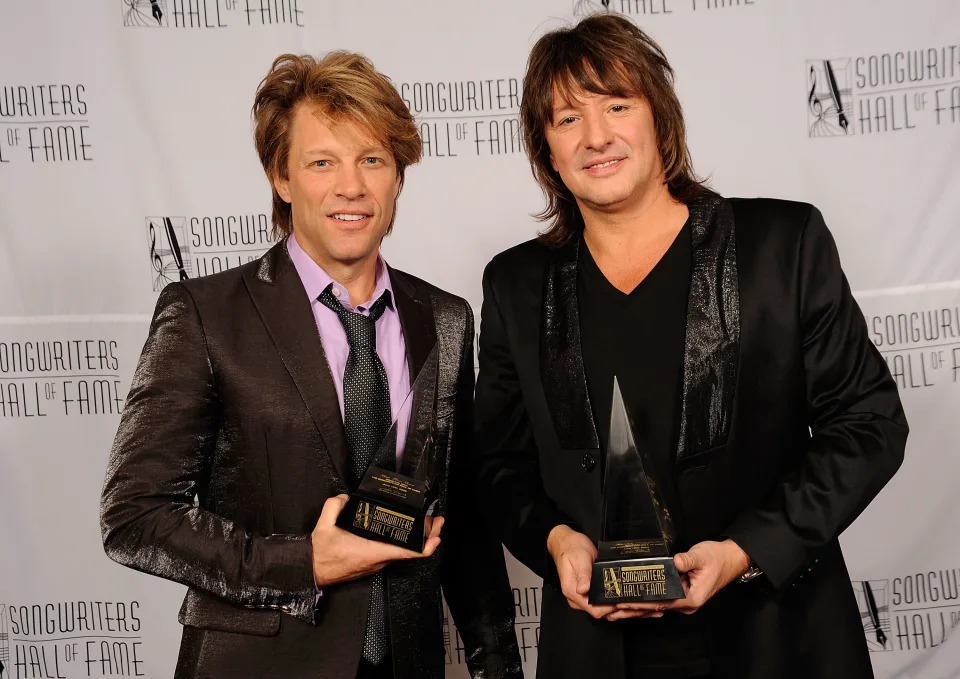 Honorees Jon Bon Jovi and Richie Sambora, holding awards, attend the 40th Annual Songwriters Hall of Fame Ceremony in 2009.