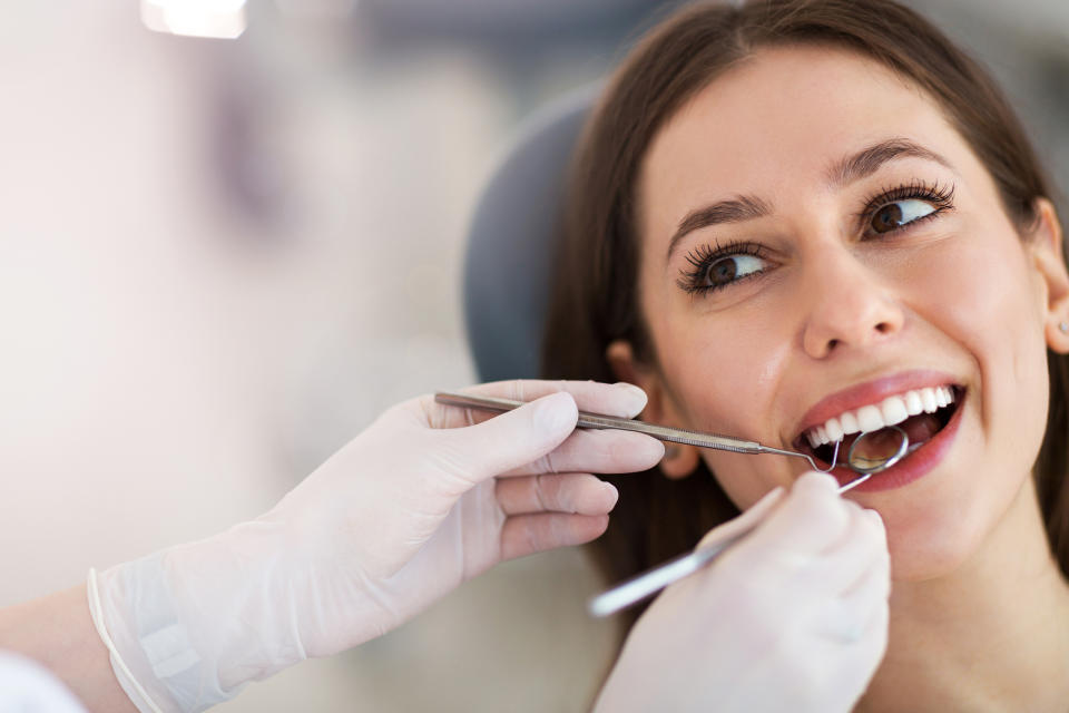 A woman receiving dental exam.