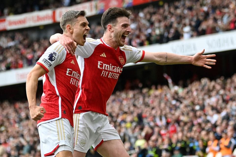 Celebration: Leandro Trossard and Declan Rice were both on target in the second half for Arsenal (AFP via Getty Images)