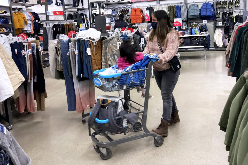 Consumers shop at a retail store in Vernon Hills, Ill., Saturday, Nov. 13, 2021. Retail sales took an unexpected dip in December 2021 in what could be a signal that the increasing weight of persistently rising inflation is prompting a pullback in consumer spending. (AP Photo/Nam Y. Huh)