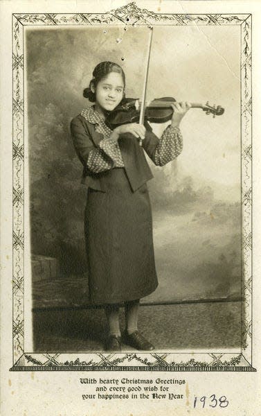 In this 1938 Christmas card, a young Rosemary Sanders poses with her violin. The following year, she would graduate from Riley High School in South Bend.