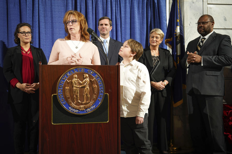 Amanda Bourland, of Louisville, Kentucky, speaks at a press conference before Kentucky Democratic Governor Andy Beshear signs an executive order to reinstate the voting rights of over 100,000 non-violent felons who have completed their sentences, at the Capitol in Frankfort, Ky., Thu, Dec. 12, 2019. Bourland was convicted of a drug offenses when he was 18 and will have her voting rights restored with today's order. (AP Photo/Bryan Woolston)