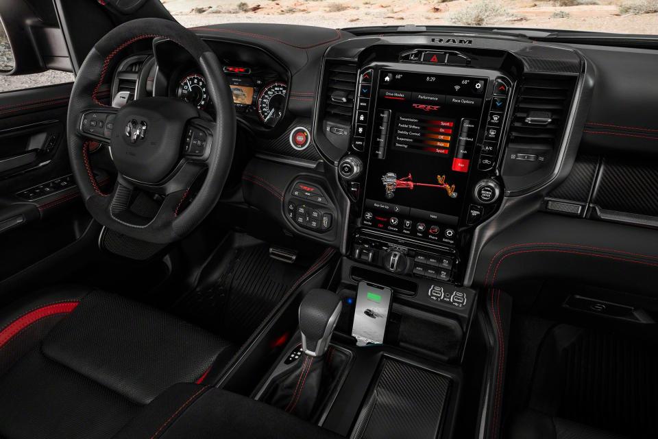 <p>It used to be that if you wanted a vehicle that could handle the wilder parts of the outside world, you had to skimp on the interior amenities. Not so much anymore. With features like adaptive cruise control available on FCA's <a href="https://www.caranddriver.com/jeep/wrangler" rel="nofollow noopener" target="_blank" data-ylk="slk:Jeep Wrangler;elm:context_link;itc:0;sec:content-canvas" class="link ">Jeep Wrangler</a>, it's not surprising that the 2021 Ram 1500 TRX is not only civilized inside, but it also houses quite a lot of technology, including things that are new or unexpected for a pickup such as launch control, an optional head-up display, and aluminum paddle shifters.</p>