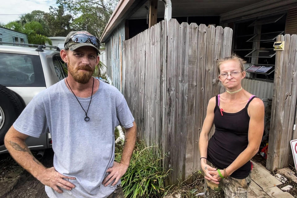 Jesse Hancock and Ria Blaight tried to salvage what they could Tuesday from their flooded home in the Twin City mobile home park. (Matt Lavietes / NBC News)