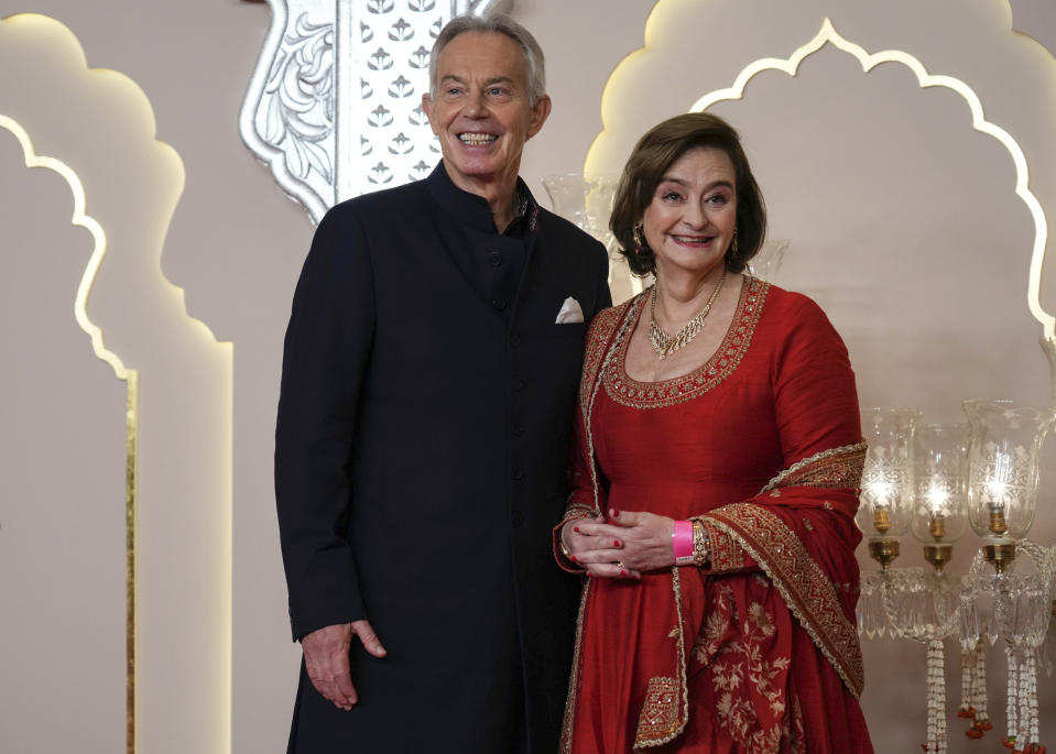 Former British Prime Minister Tony Blair with his wife, Cherie Blair, who wore a scarlet and gold sari.