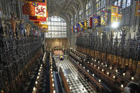 The royal family members and guests sits socially distanced as the flag draped coffin sits on a bier, centre, during the funeral for Britain Prince Philip inside St George's Chapel in Windsor Castle, Windsor, England, Saturday April 17, 2021. Prince Philip died April 9 at the age of 99 after 73 years of marriage to Britain's Queen Elizabeth II. (Yui Mok/Pool via AP)