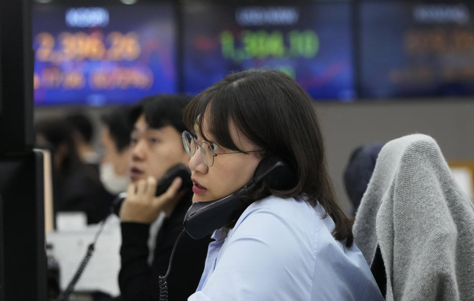 A currency trader watches monitors at the foreign exchange dealing room of the KEB Hana Bank headquarters in Seoul, South Korea, Tuesday, March 21, 2023. sian stock markets followed Wall Street higher on Tuesday ahead of a Federal Reserve decision on another possible interest rate hike amid worries about global banks. (AP Photo/Ahn Young-joon)