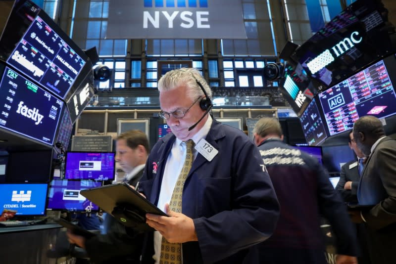 FILE PHOTO: Traders work on the floor at the New York Stock Exchange (NYSE) in New York, U.S., May 20, 2019. REUTERS/Brendan McDermid