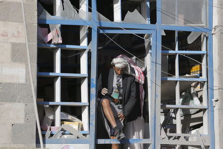 A vendor steps out of his shop damaged by a Saudi-led air strike in Yemen's capital Sanaa January 4, 2016. REUTERS/Khaled Abdullah