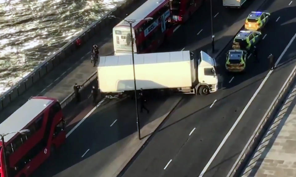 In this image made from video provided by Luke Poulton, armed police surround a truck parked across lanes of traffic on London Bridge, following an incident in central London, Friday, Nov. 29, 2019. British police have shot a man on London Bridge in the heart of Britain’s capital after a stabbing that left several people wounded. The Metropolitan Police force said the circumstances were still unclear, but “as a precaution, we are currently responding to this incident as though it is terror-related.” (Luke Poulton via AP)