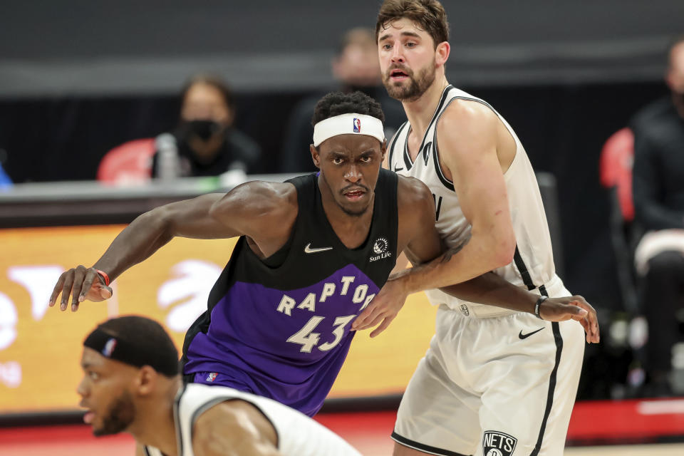 Toronto Raptors' Pascal Siakam (43) is defended by Brooklyn Nets' Joe Harris during the second half of an NBA basketball game Wednesday, April 21, 2021, in Tampa, Fla. The Raptors won 114-103. (AP Photo/Mike Carlson)